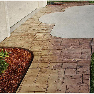 New concrete sidewalk and driveway with stamped and colored concrete