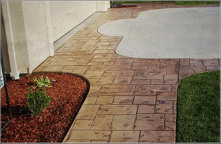 New concrete sidewalk and driveway with stamped and colored concrete