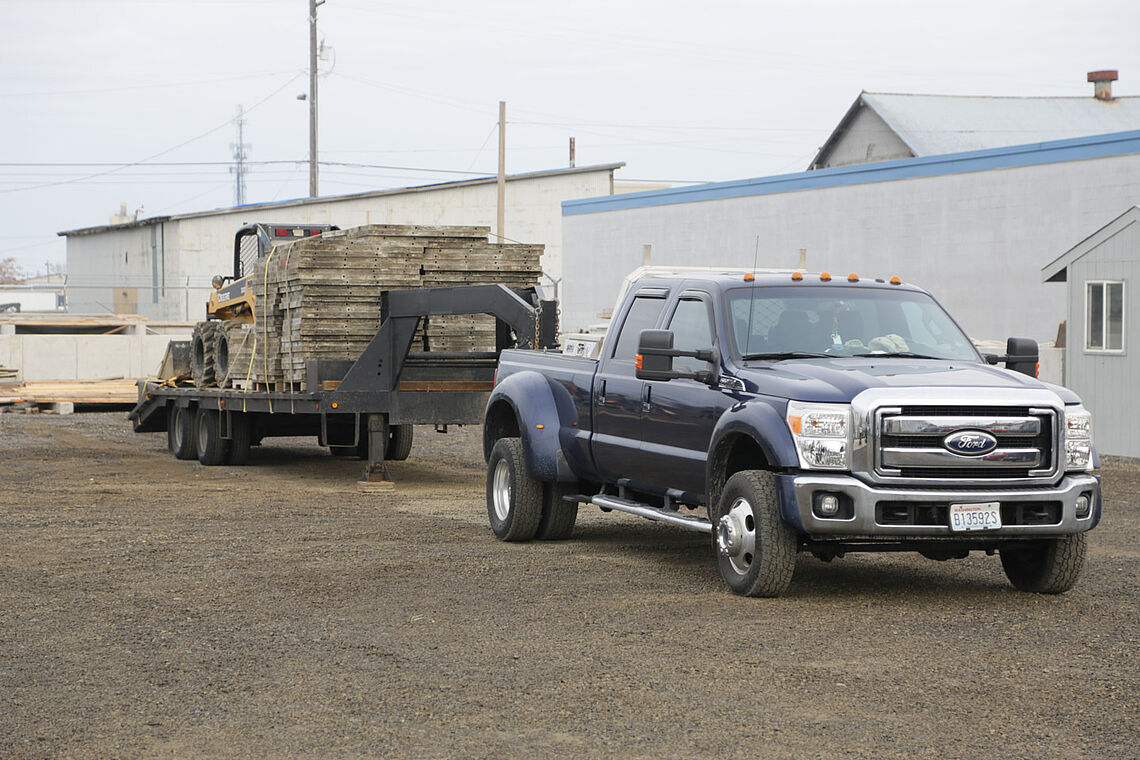 One of our trucks hooked up to trailed loaded with concrete forms