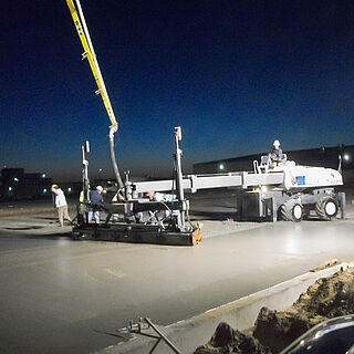 Pump truck working with Somero laser screed system on a new concrete pour